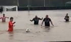Football team take to pitch despite floodwaters during Storm Bert – video