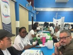 Multi-Department teams support Immigration Ministry mobile hub in Belize City