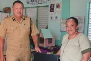Assistant Commissioner of Police Howell Gillett provides desktop computers to support educational programs at primary schools